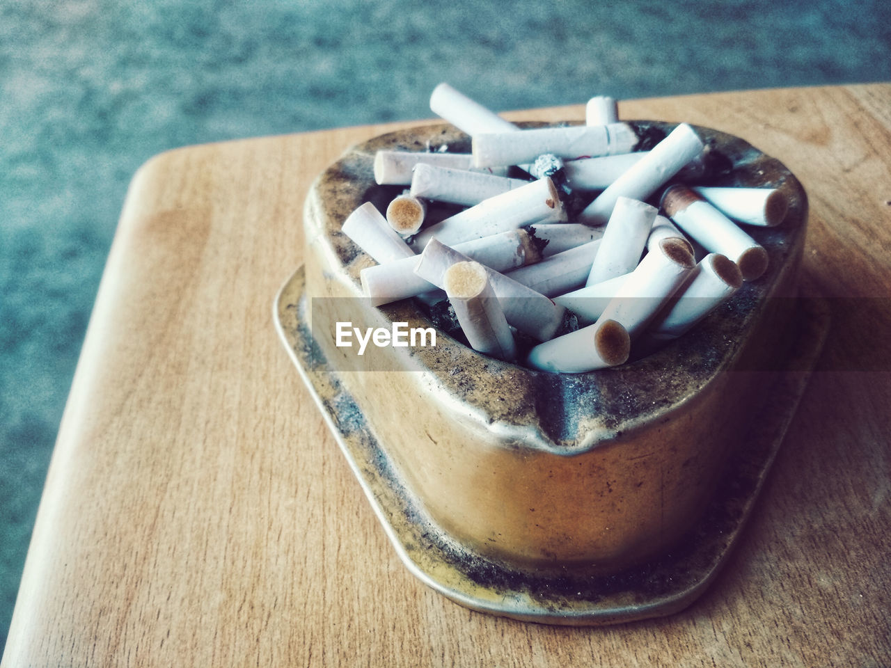 High angle view of cigarette butts in container