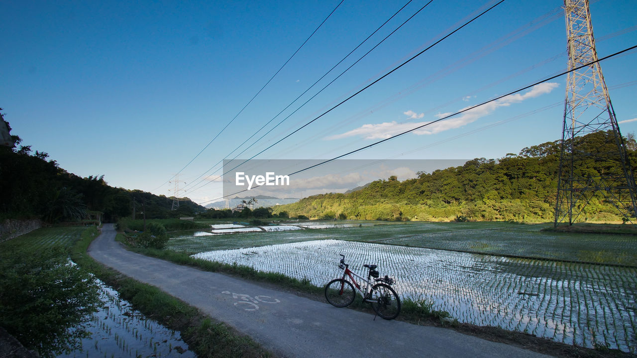 Bike on bike path along electric lines