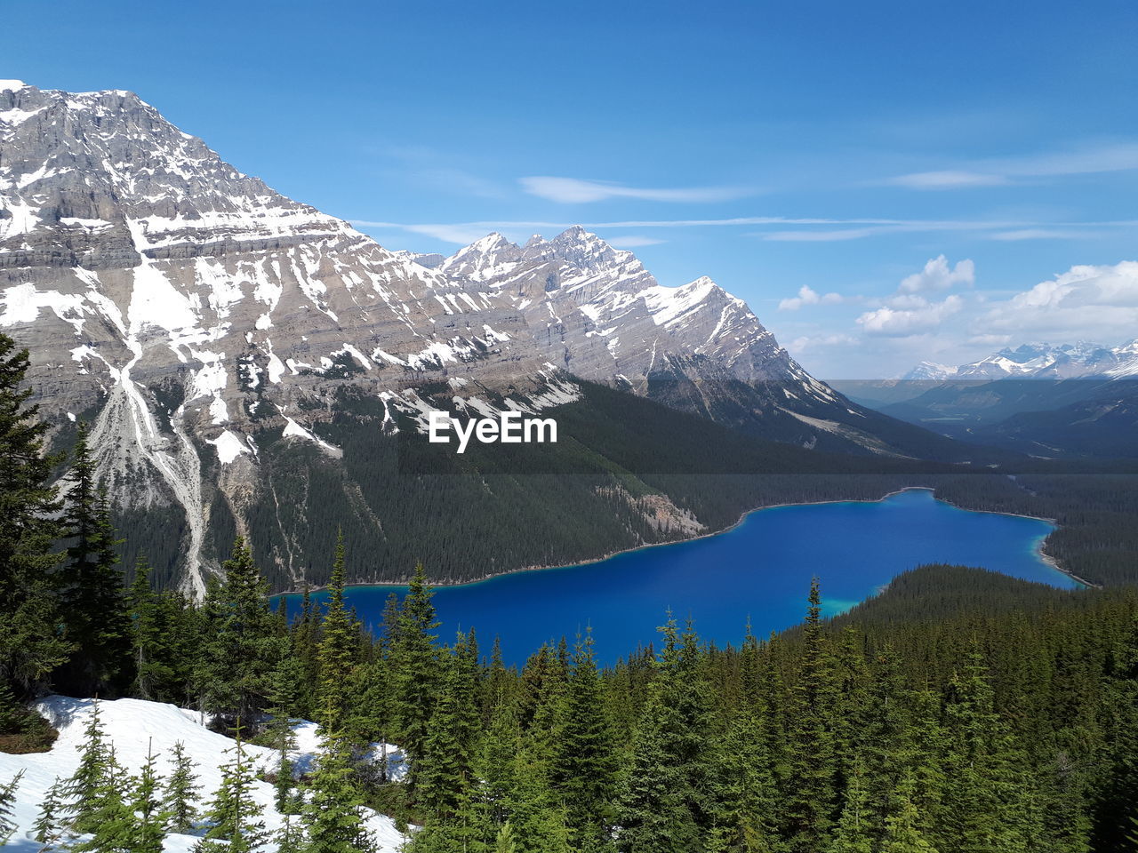 Scenic view of snowcapped mountains against blue sky