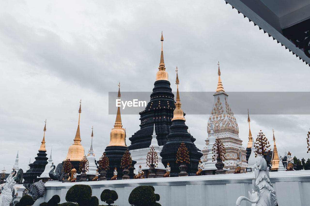 Low angle view of temple against cloudy sky