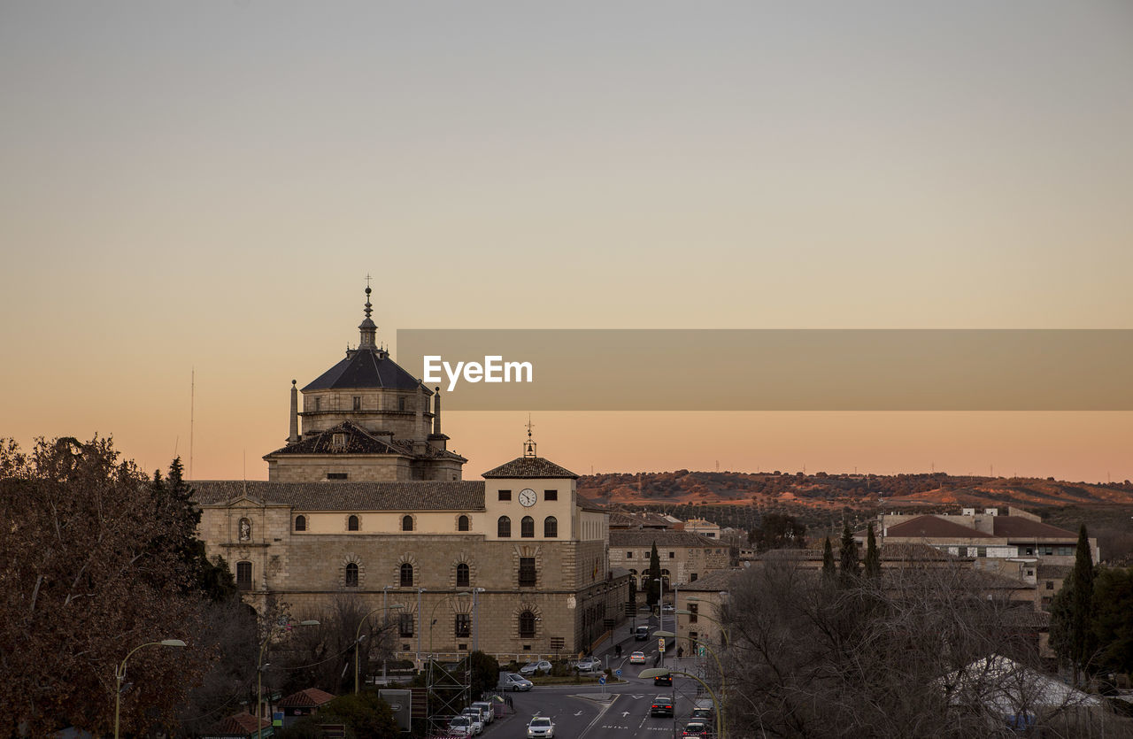 Historic building by street in toledo against clear sky