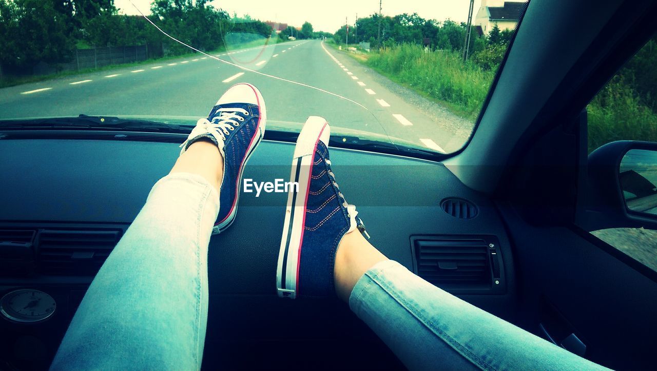 Low section of woman on car dashboard