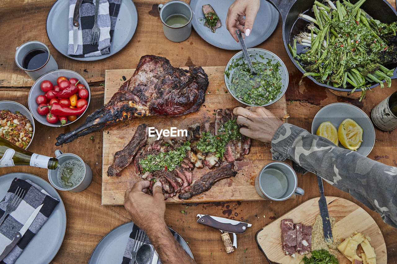 Summer barbecue spread with steak and venison and chimichurri