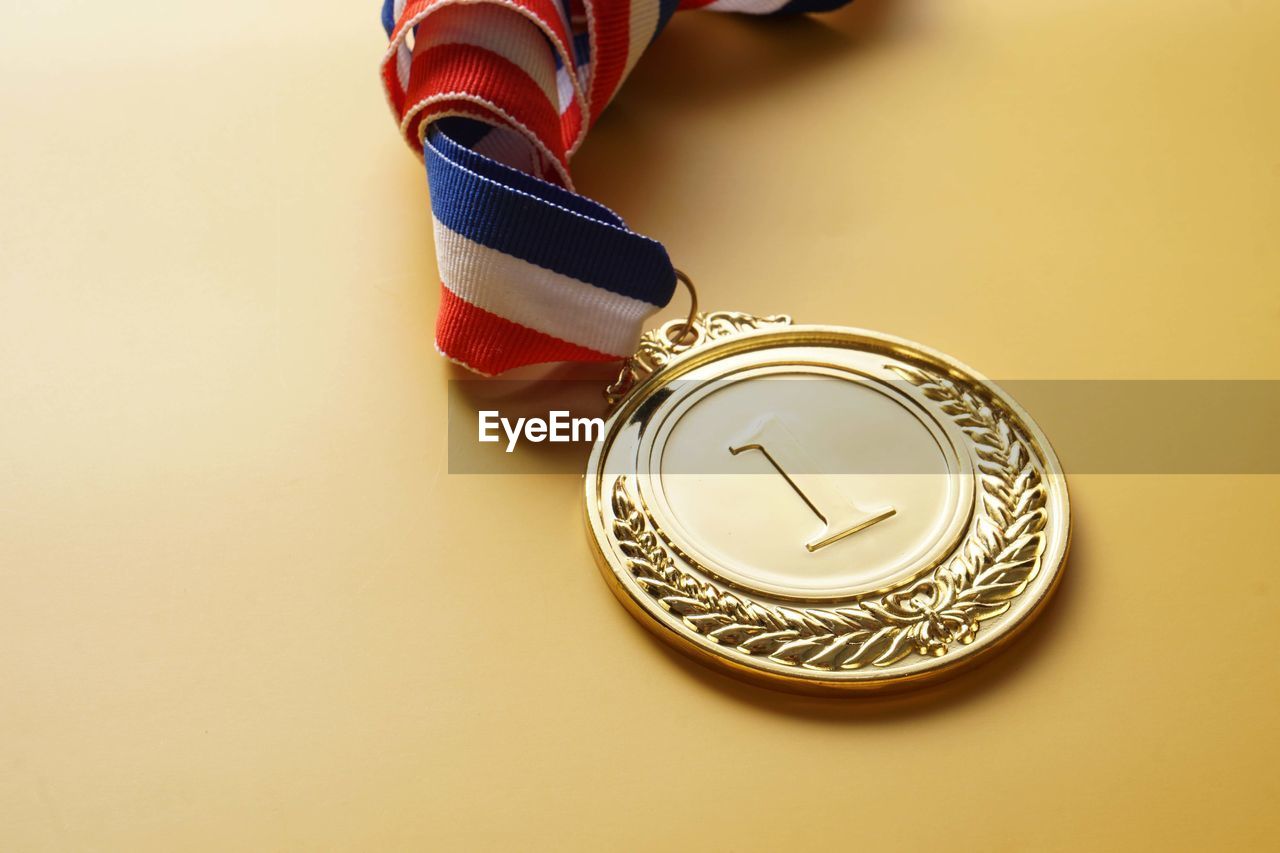 Close-up of award over yellow background