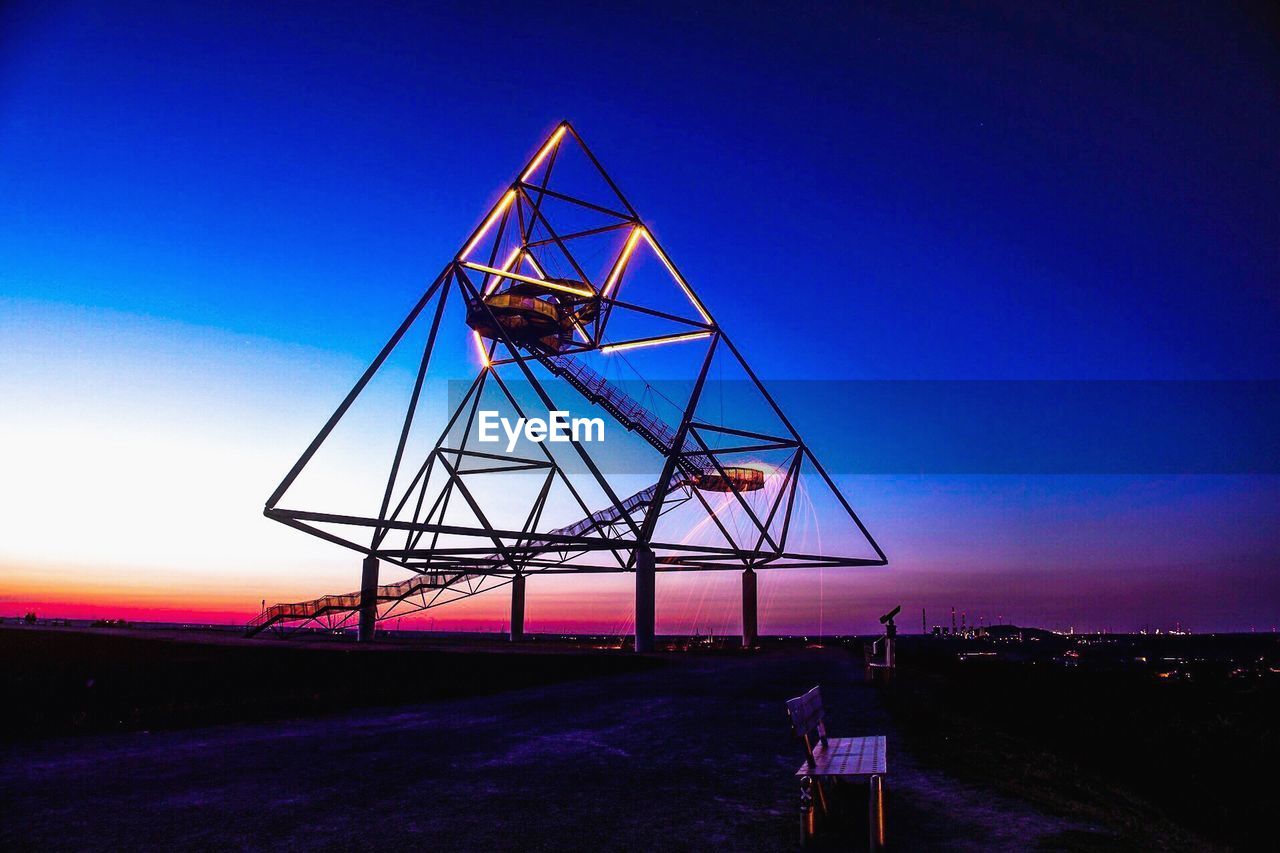 LOW ANGLE VIEW OF COMMUNICATIONS TOWER AGAINST CLEAR BLUE SKY