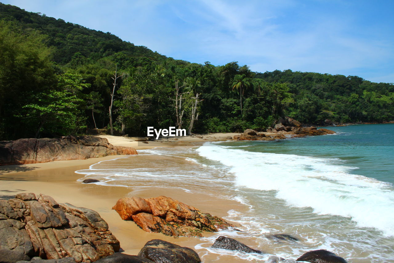 View of calm beach against mountain