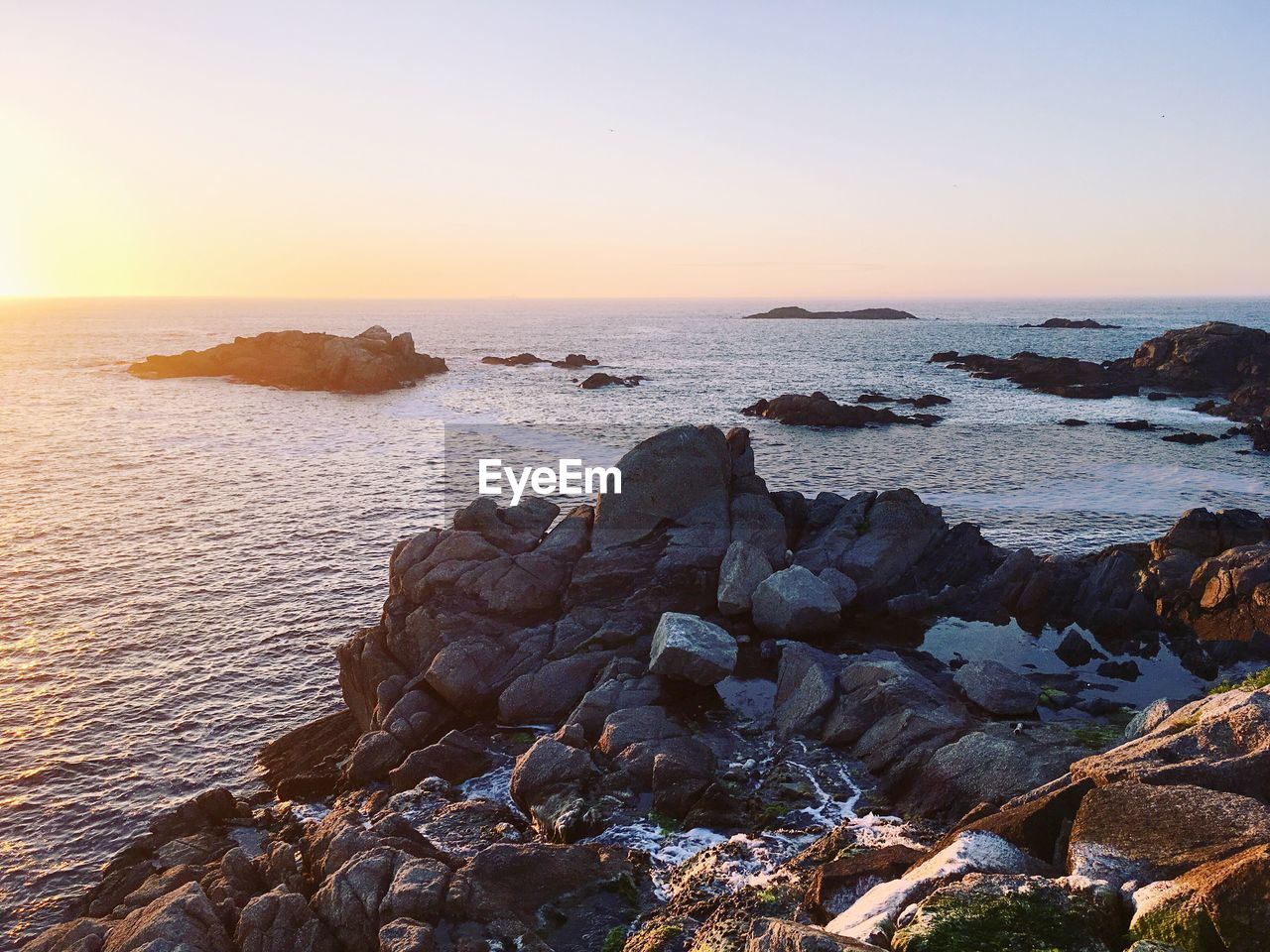 Scenic view of sea against clear sky during sunset