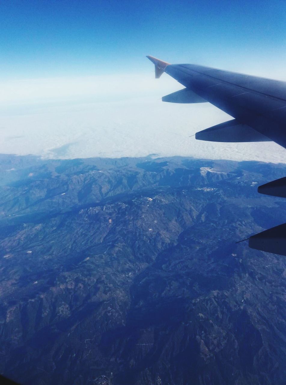 AERIAL VIEW OF LANDSCAPE AND AIRPLANE WING