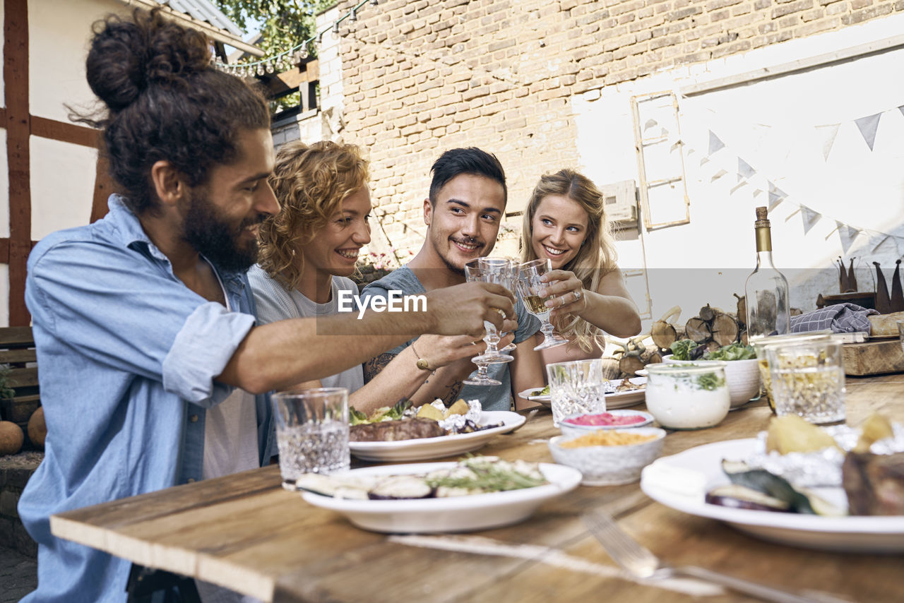 Friends having fun at a barbecue party, eating together