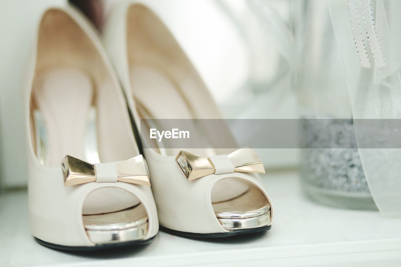 Close-up of high heels on table