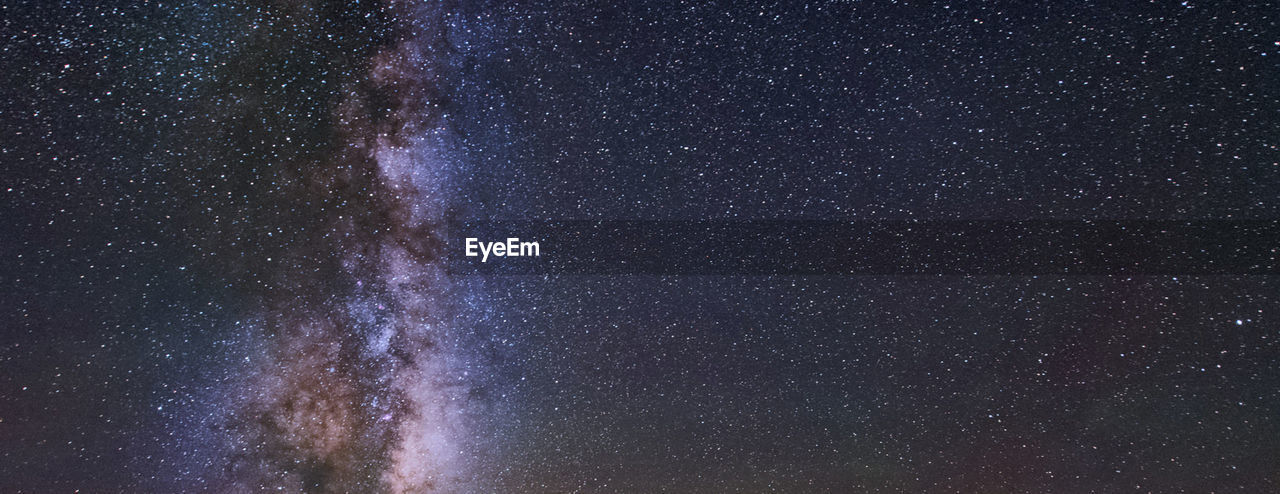 LOW ANGLE VIEW OF STAR FIELD AGAINST SKY