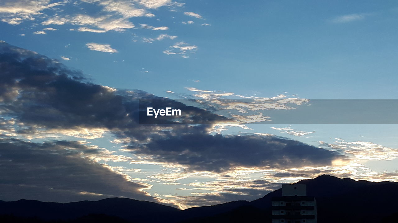 LOW ANGLE VIEW OF SKY AND MOUNTAIN AGAINST THE BACKGROUND