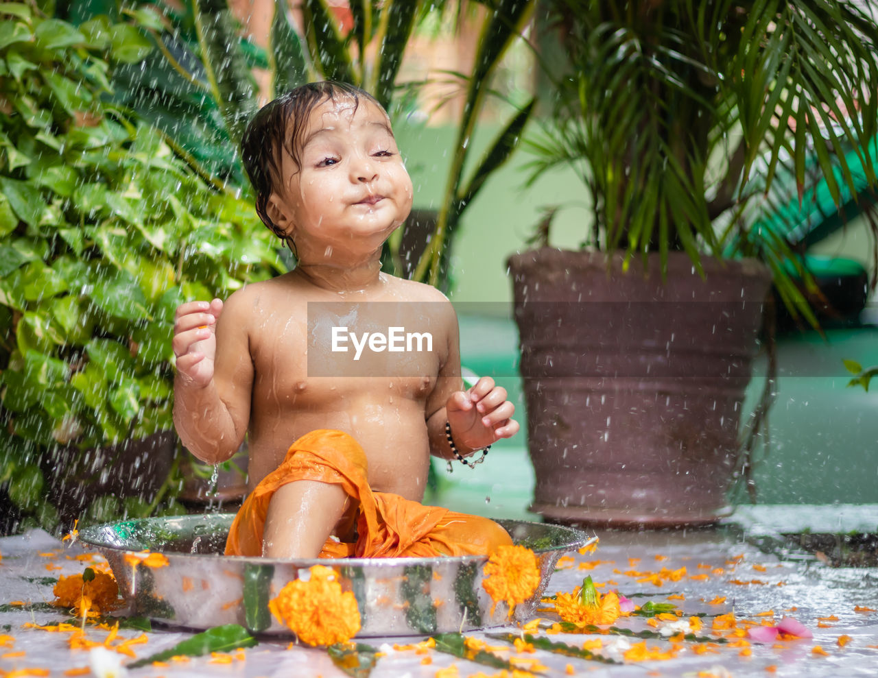 water, child, childhood, one person, nature, wet, men, happiness, fun, smiling, baby, swimming, emotion, tropical climate, lifestyles, enjoyment, plant, taking a bath, toddler, outdoors, flower, food and drink, holiday, leisure activity, front or back yard, bathtub, day, summer, portrait, domestic bathroom, splashing, cheerful, vacation, trip, motion, refreshment, cleaning, front view, bathing, person