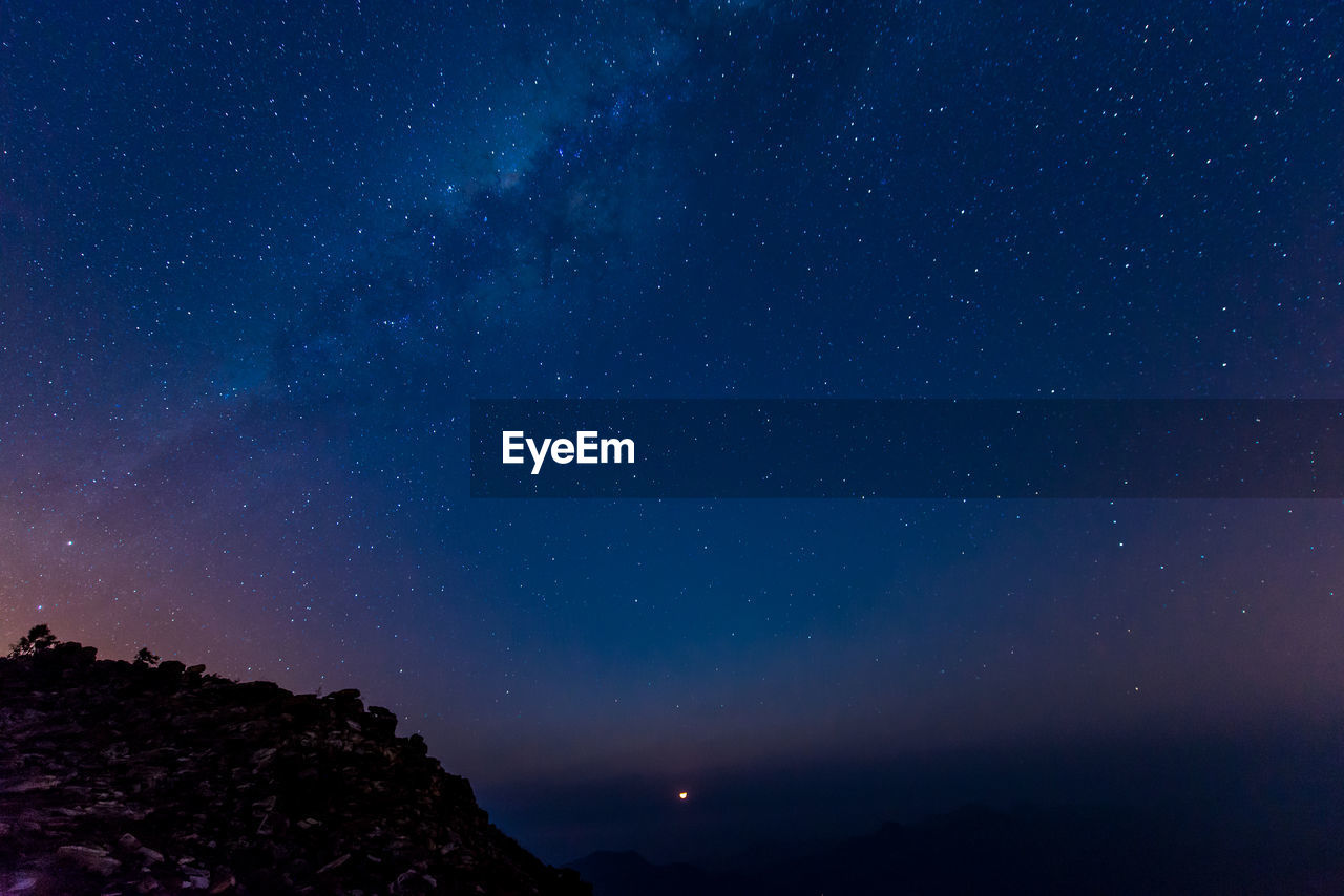 low angle view of mountain against sky at night