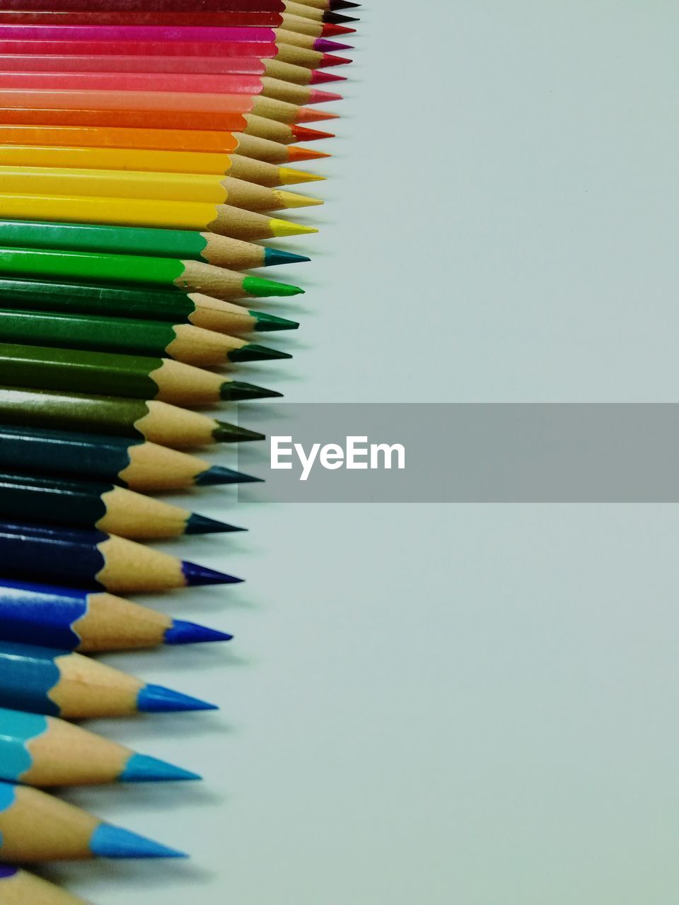 Close-up of multi colored pencils against white background