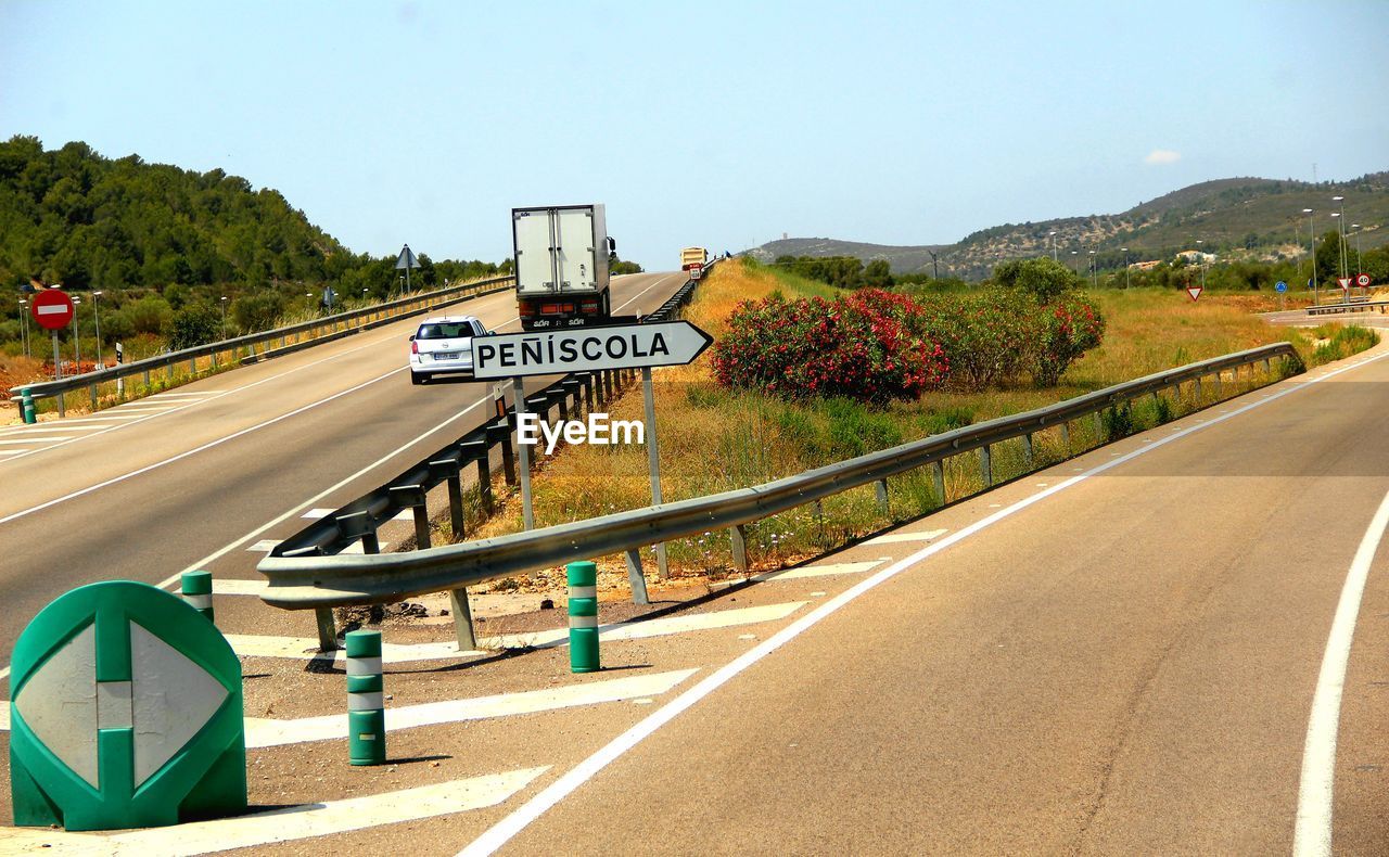 Road sign against clear sky