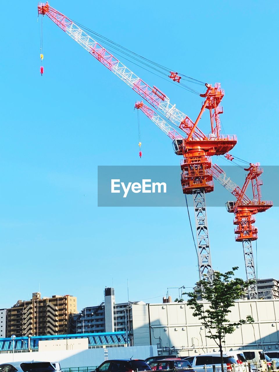 LOW ANGLE VIEW OF CRANES AGAINST SKY