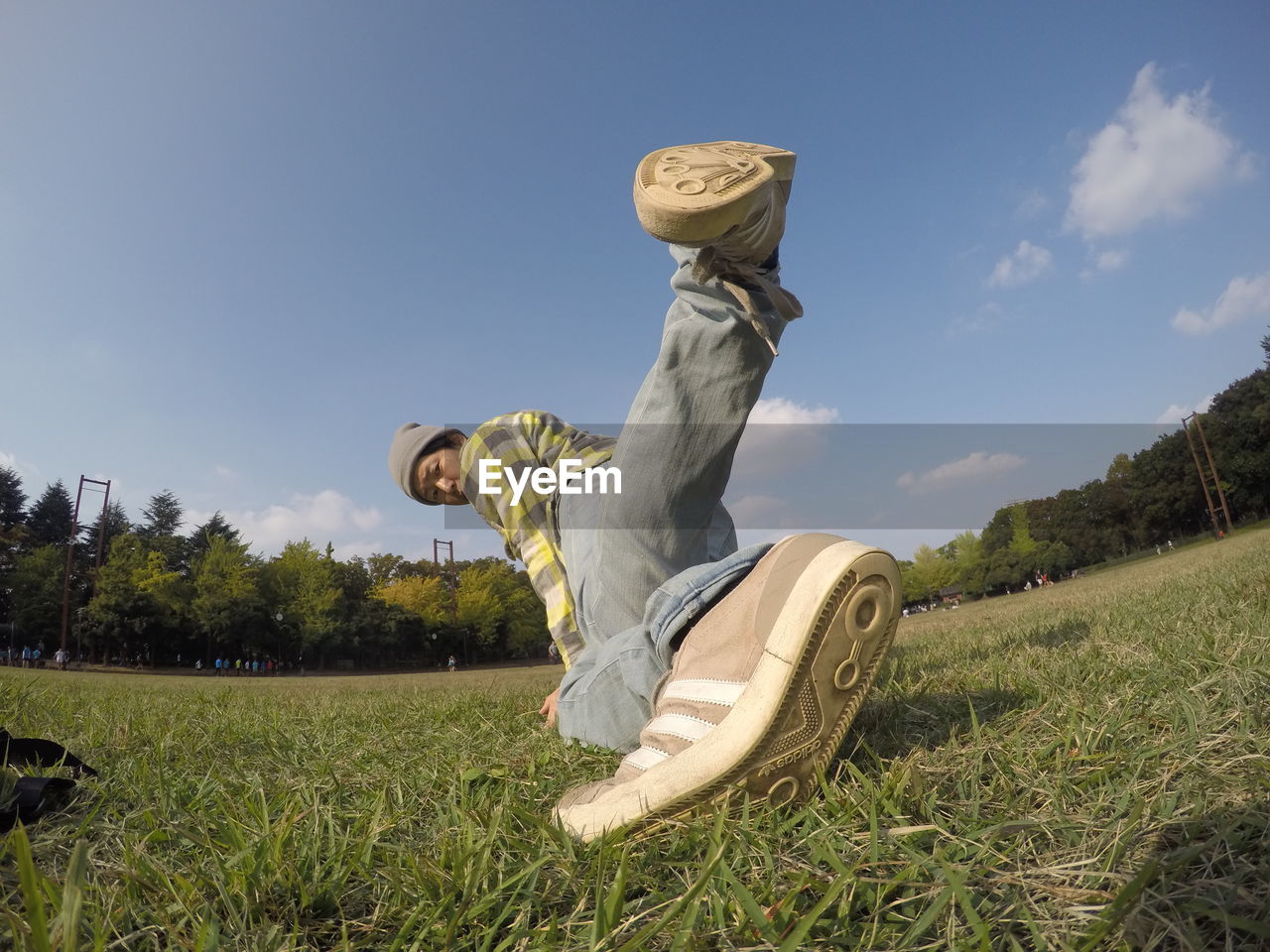 STATUES ON GRASSY FIELD AGAINST SKY