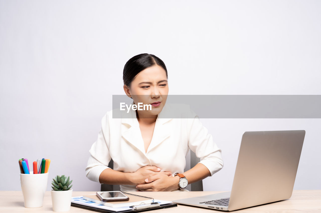 YOUNG WOMAN USING MOBILE PHONE