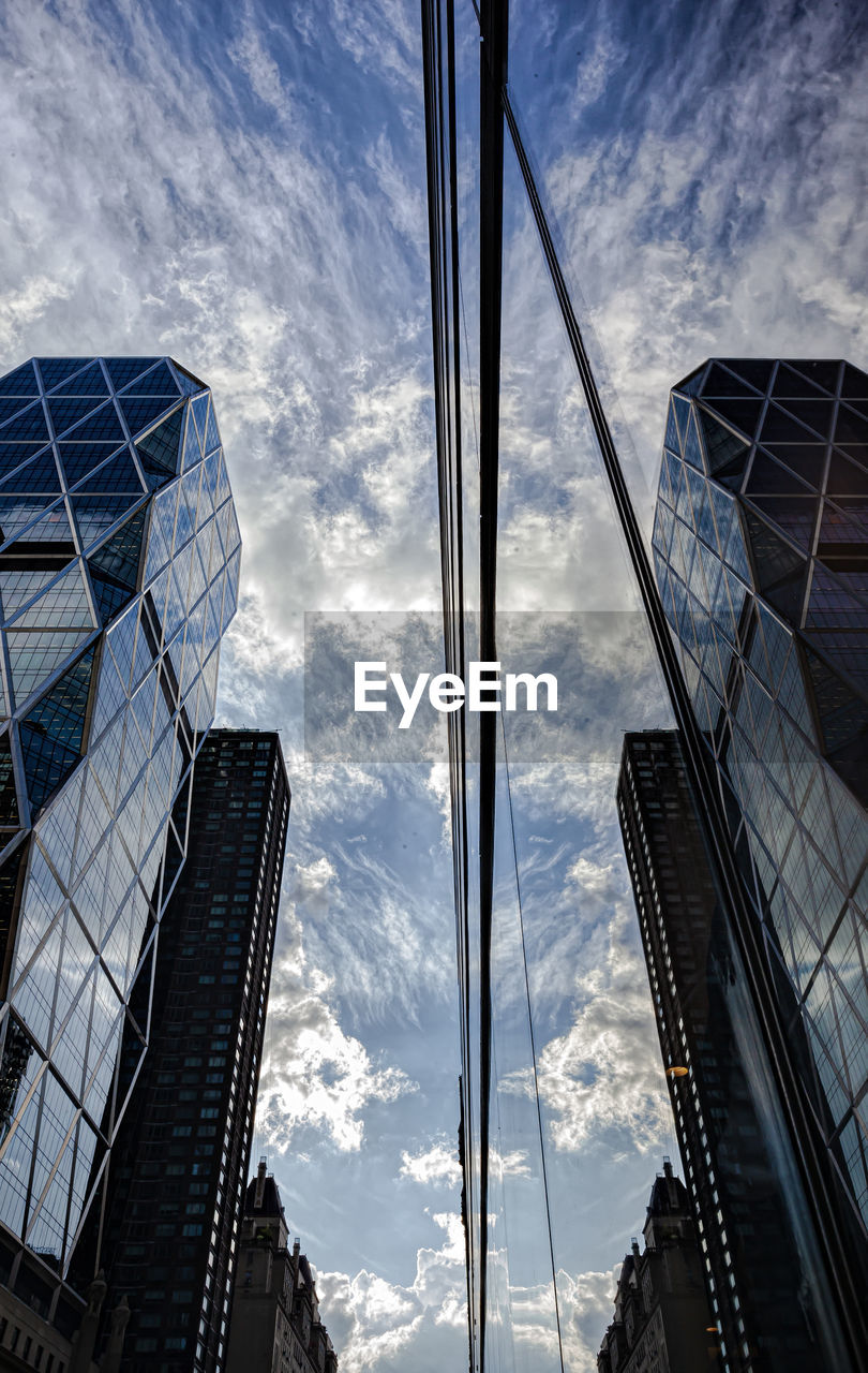 LOW ANGLE VIEW OF GLASS BUILDING AGAINST SKY