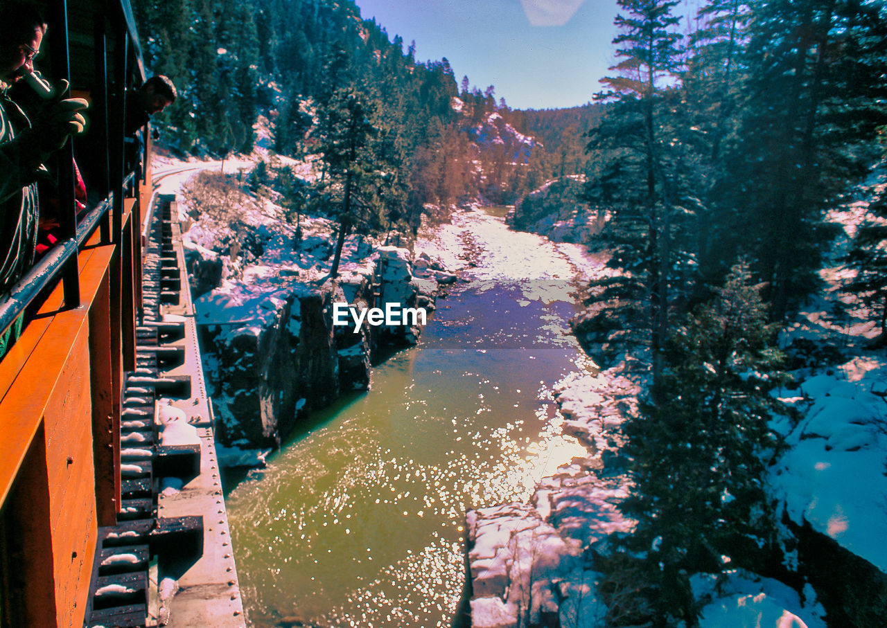 High angle view of river amidst trees in city