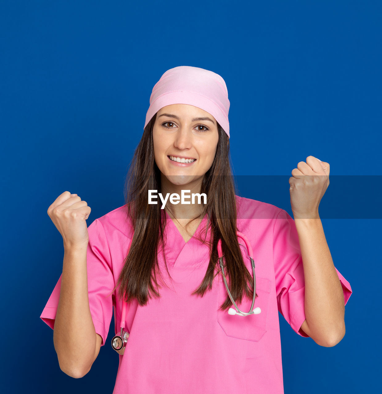 PORTRAIT OF YOUNG WOMAN AGAINST BLUE BACKGROUND