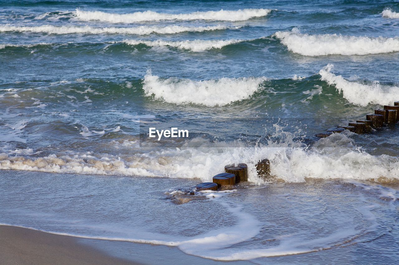 WAVES RUSHING TOWARDS SHORE AT BEACH