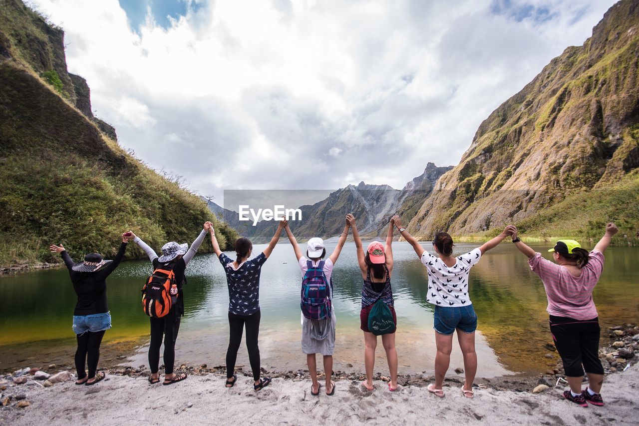 HIGH ANGLE VIEW OF PEOPLE STANDING ON MOUNTAIN