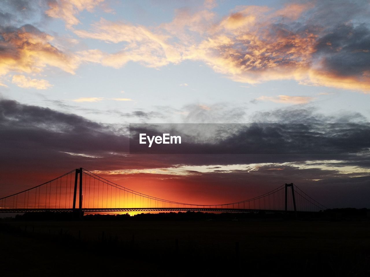 VIEW OF SUSPENSION BRIDGE DURING SUNSET