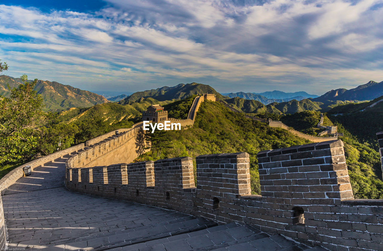 BUILT STRUCTURE ON MOUNTAIN AGAINST SKY