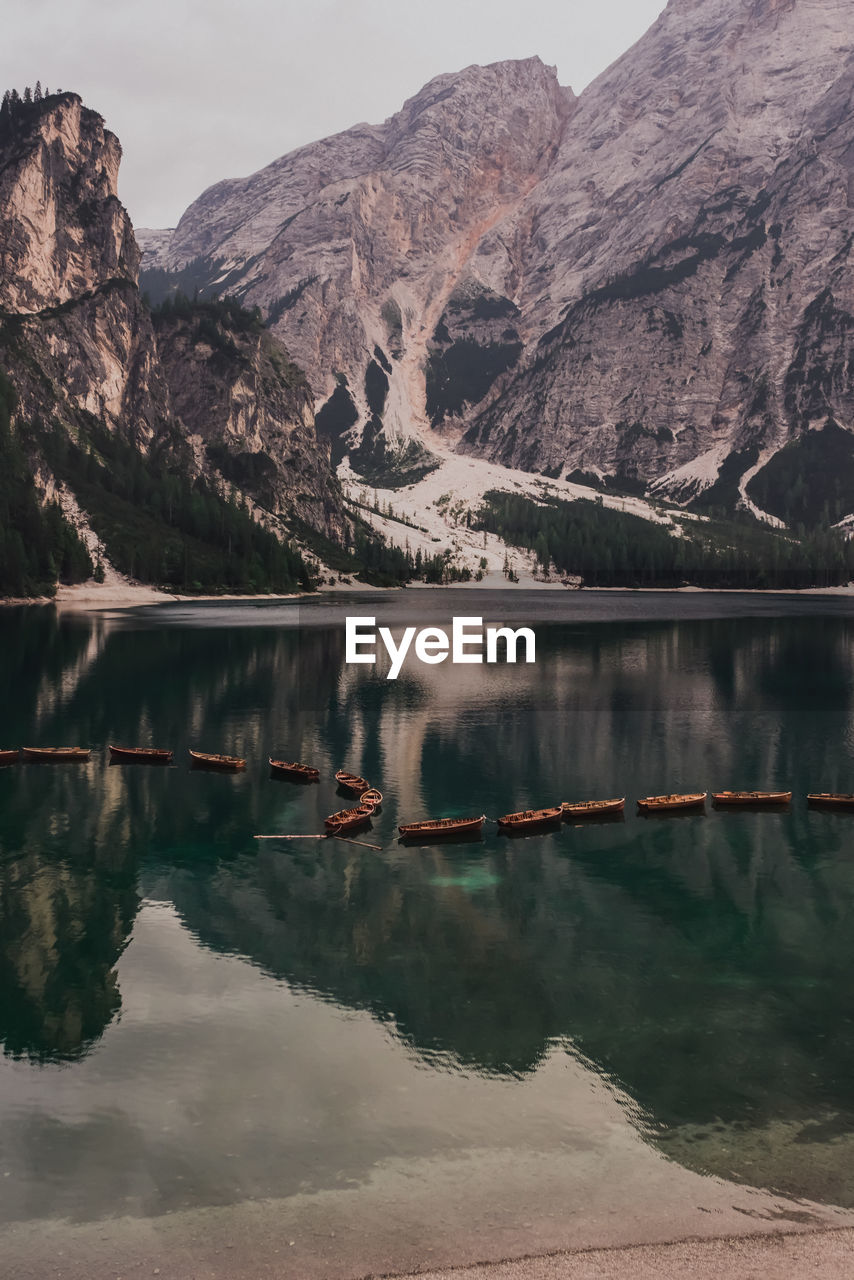 scenic view of lake by mountains against sky