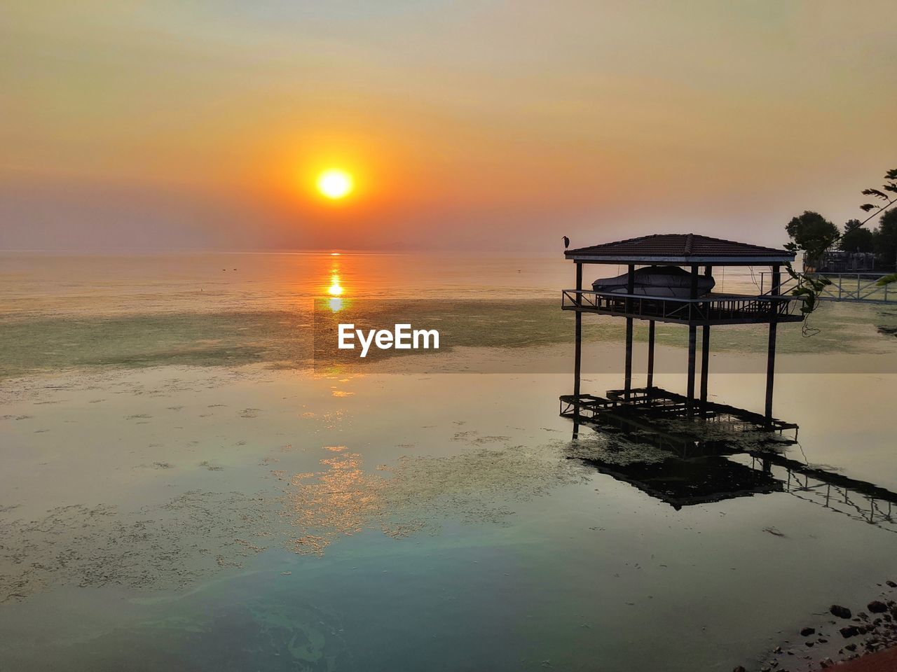 SCENIC VIEW OF SUNSET OVER SEA