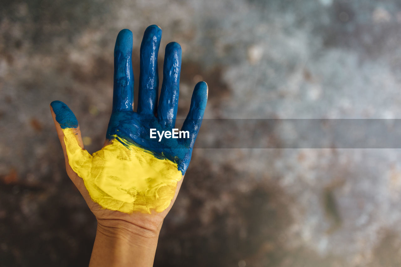 Female hands painted in the colors of the flag of ukraine. no war and peace concept.