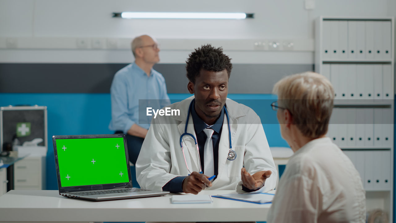 Doctor talking with patient in clinic