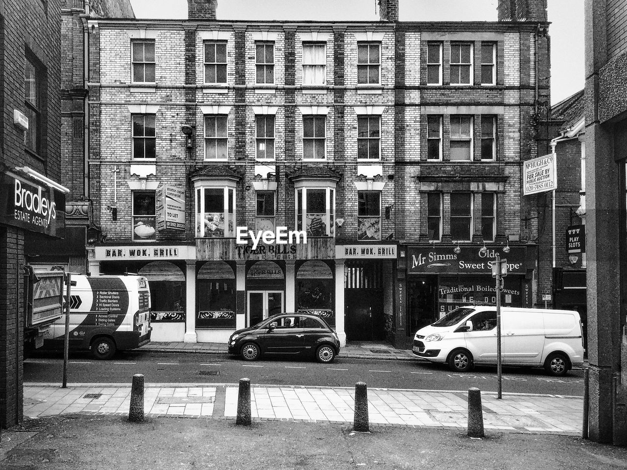 Vehicles on road against building
