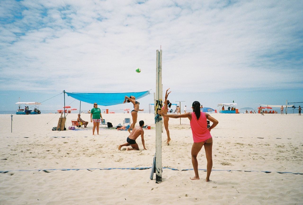 Group of people playing beach volleyball