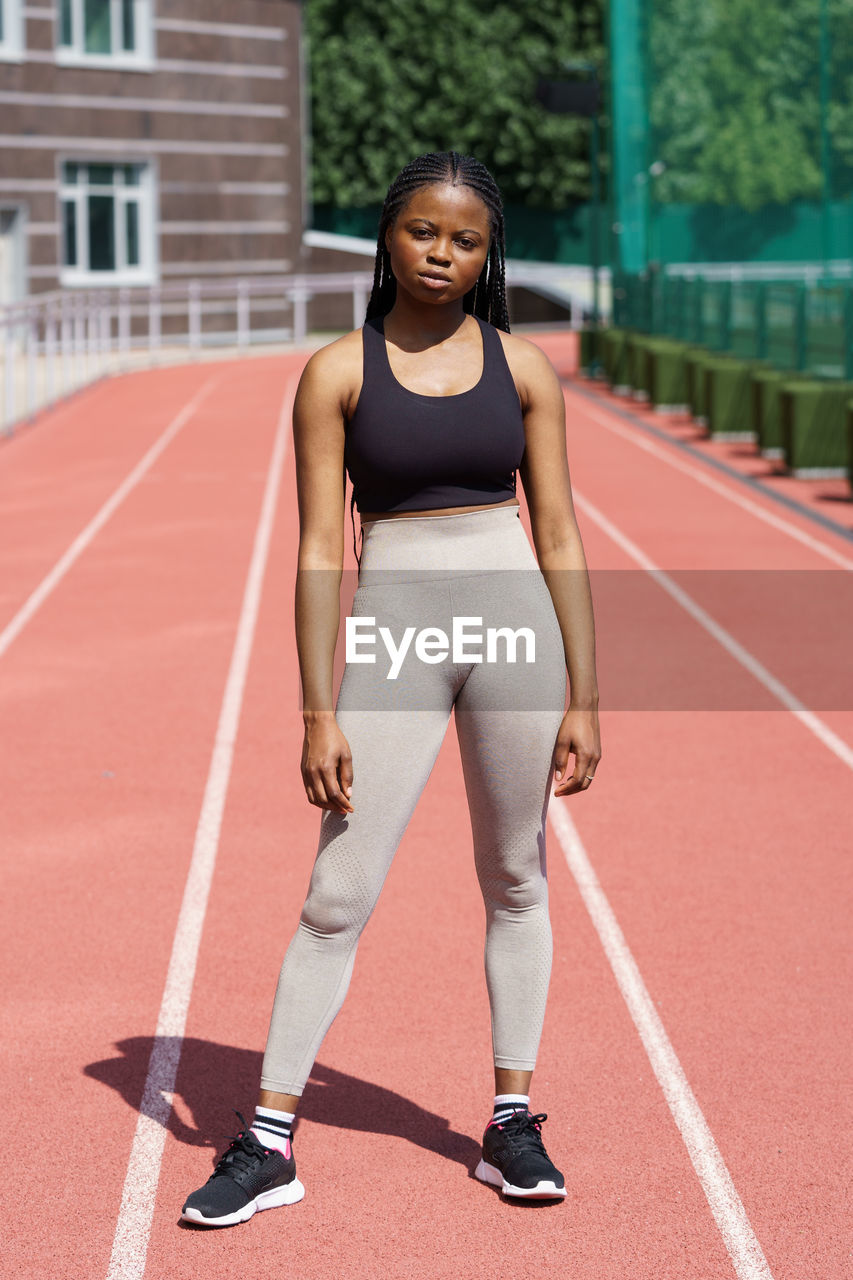 Youth african american woman student in athletic attire poses for college sports team album
