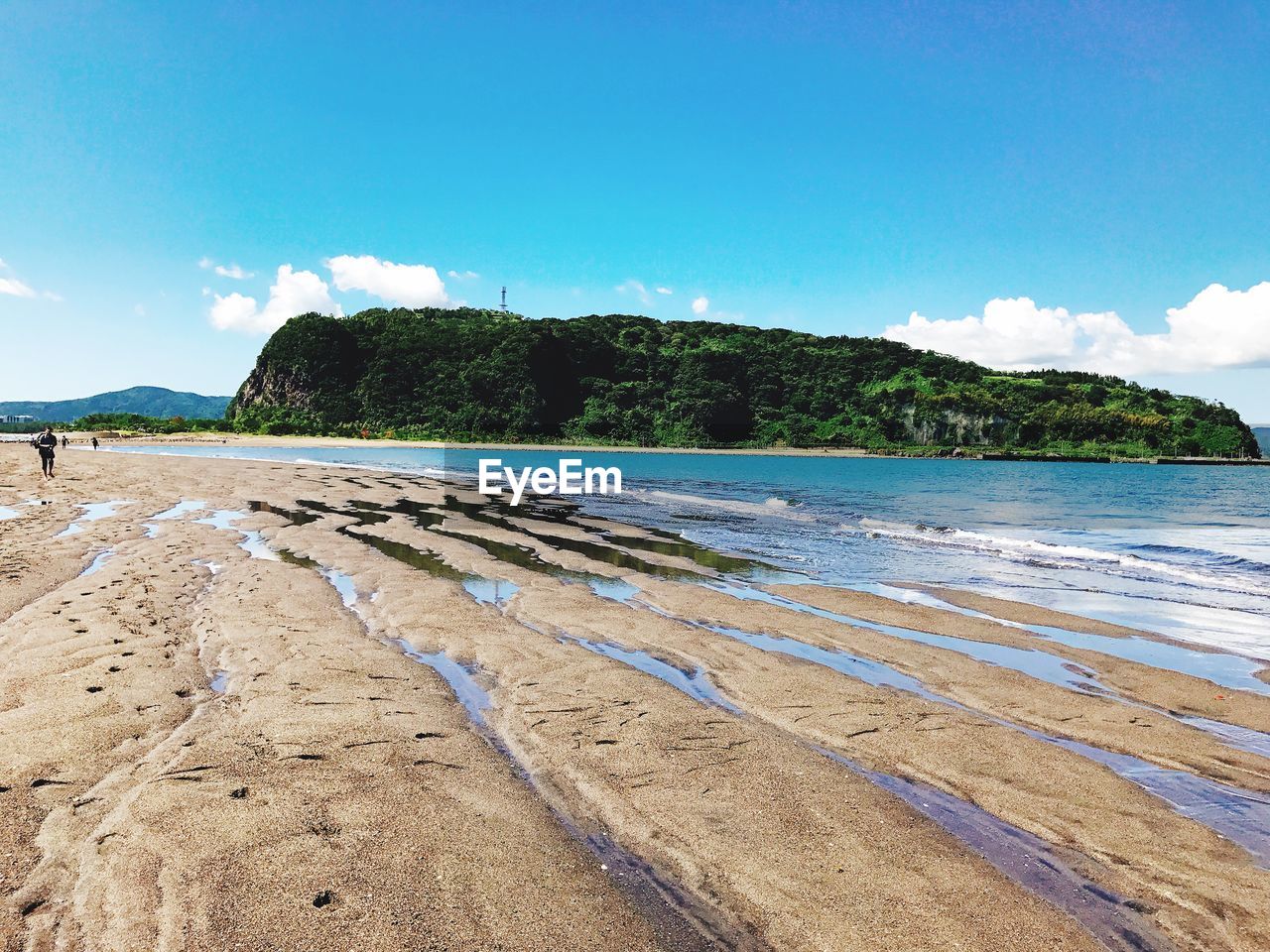 Scenic view of beach against blue sky