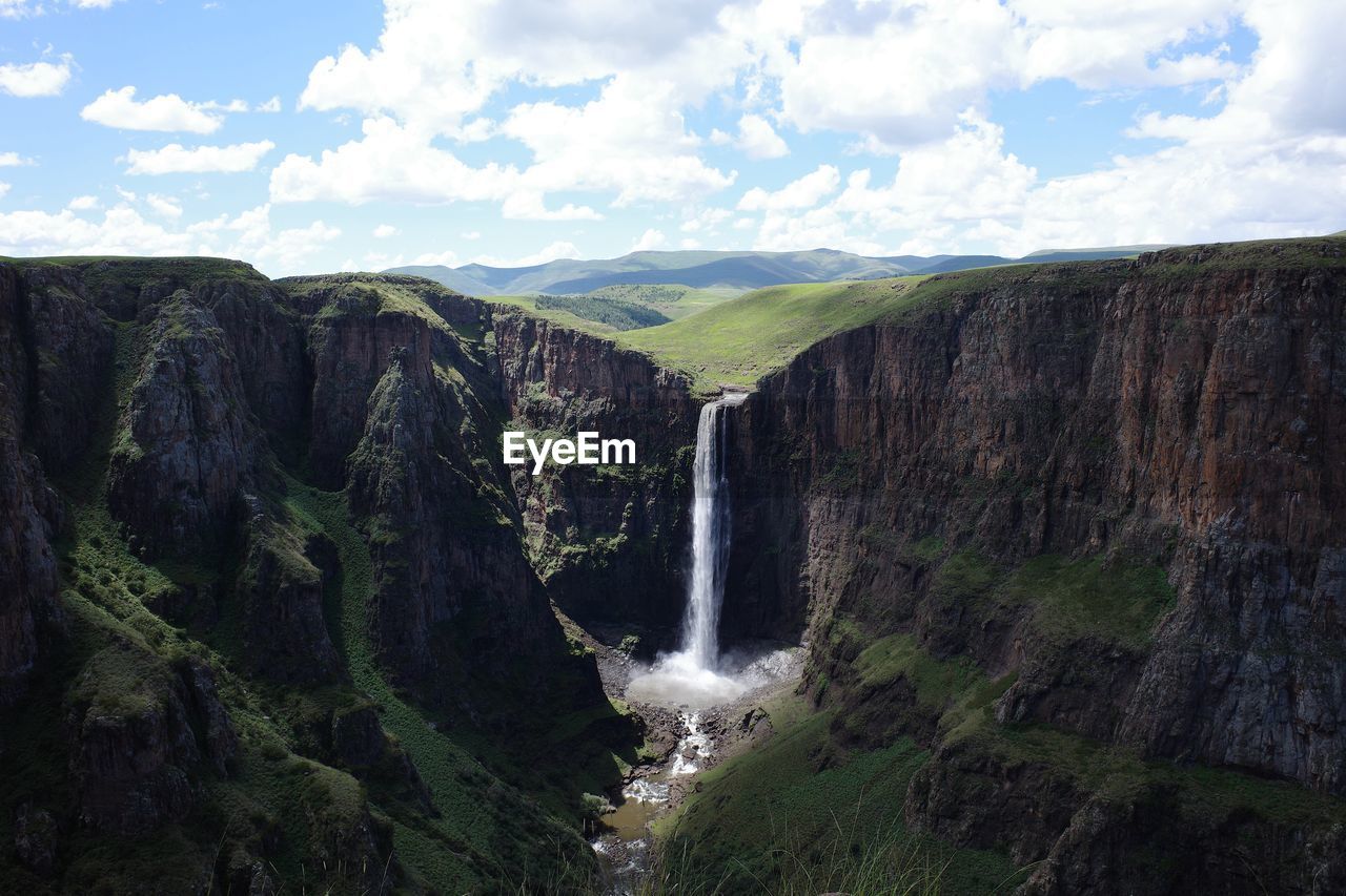 panoramic view of waterfall in forest against sky