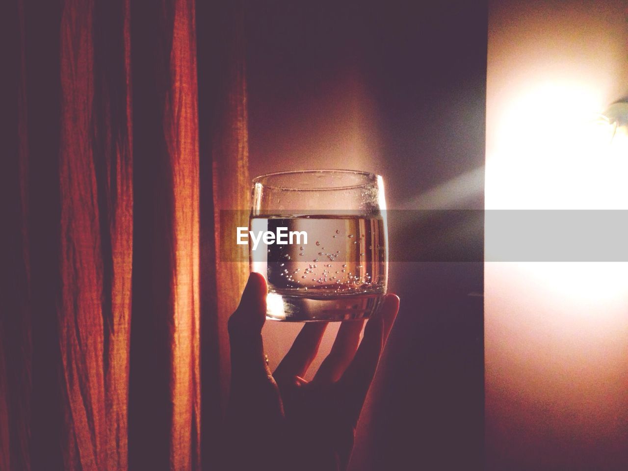 Cropped image of person holding glass