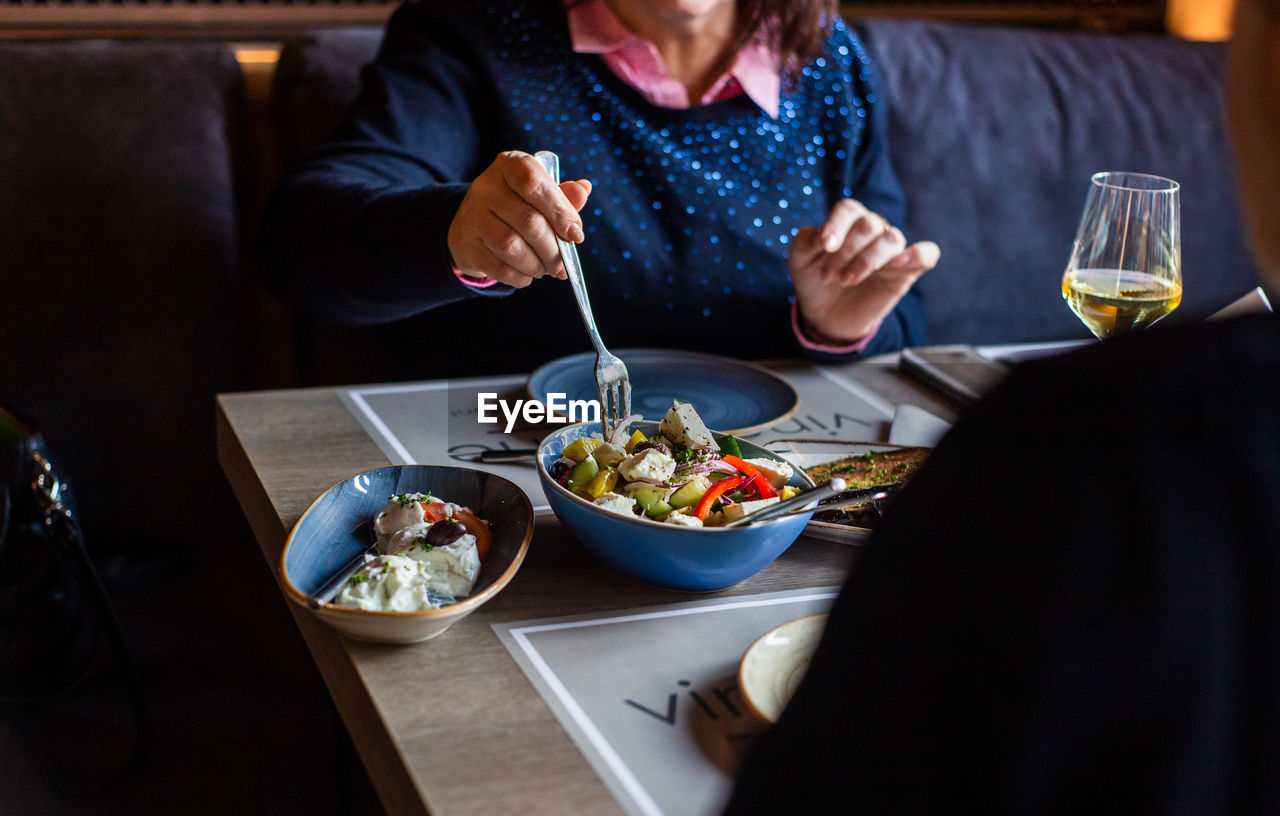 High angle view of woman eating food in restaurant