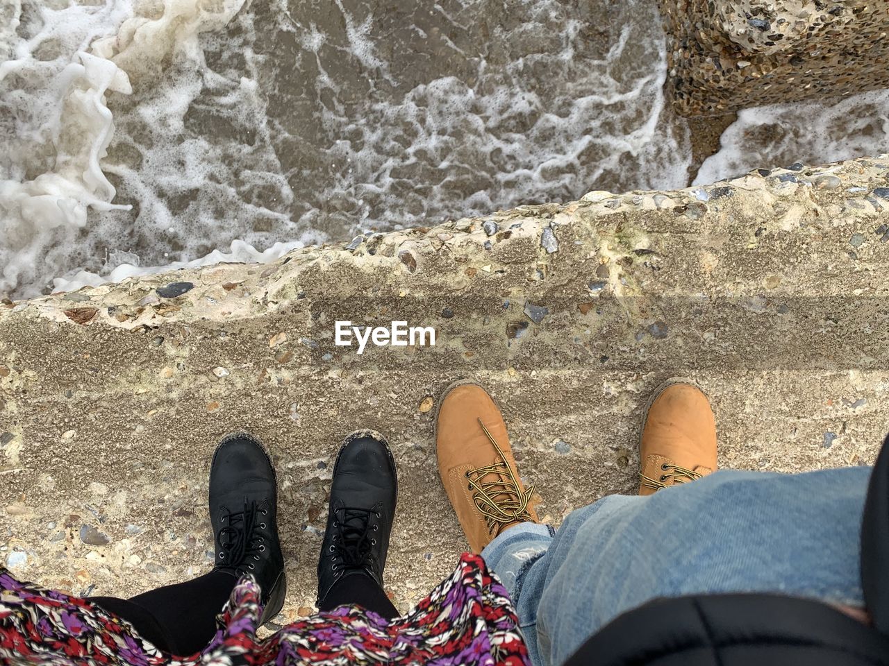 Low section of man and woman at beach