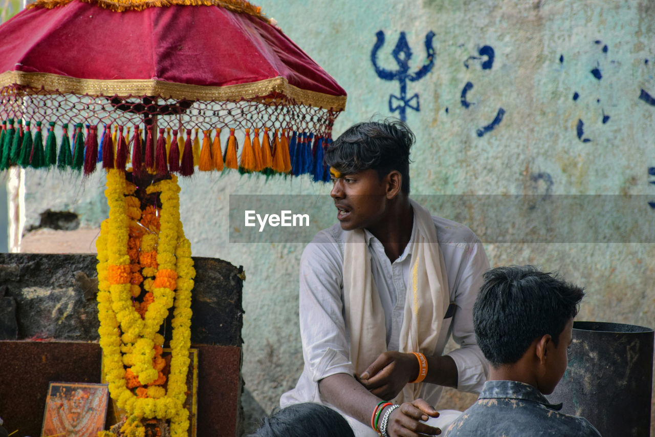 Young man wearing traditional clothing looking away