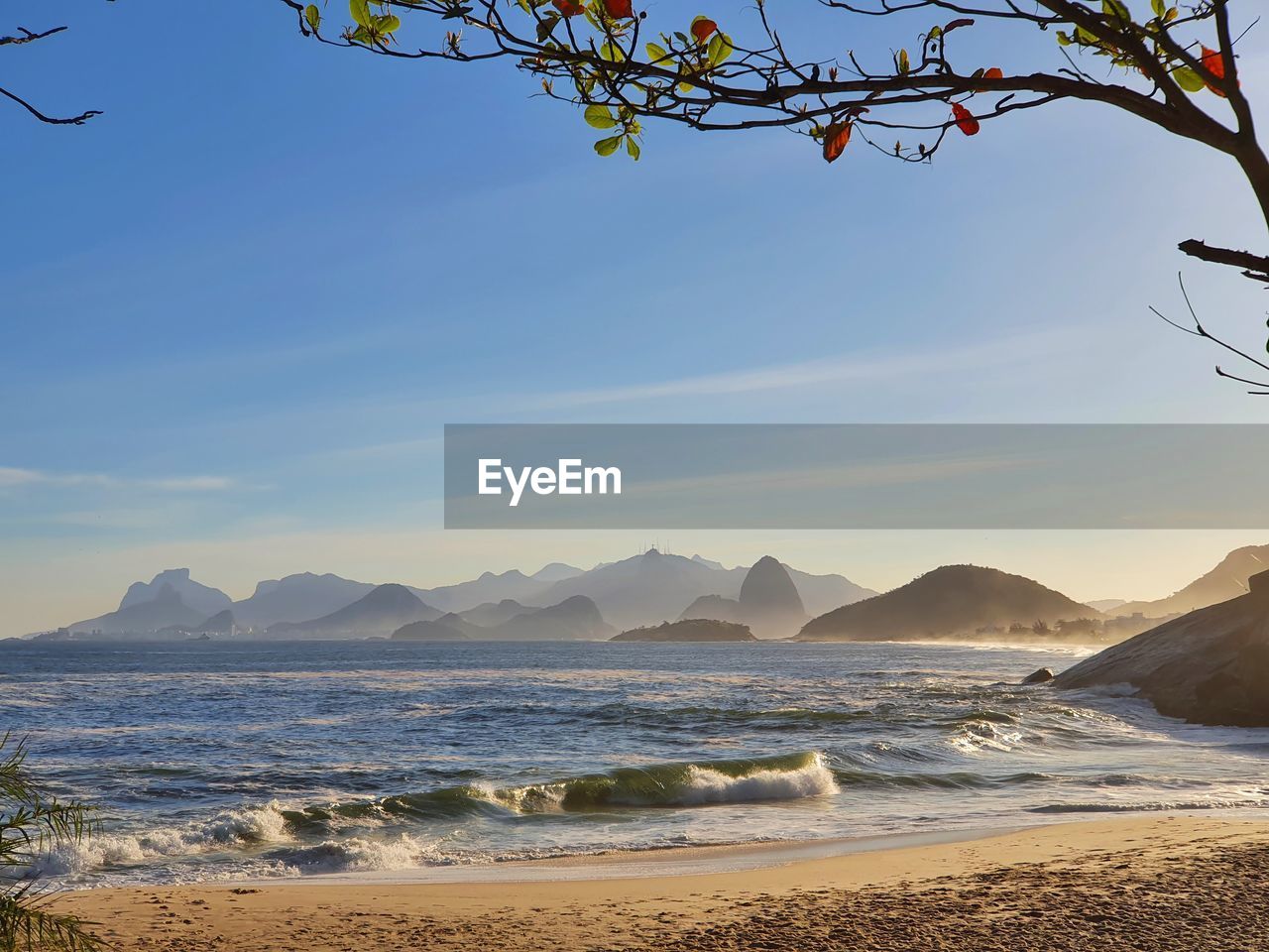 SCENIC VIEW OF BEACH AND MOUNTAINS AGAINST SKY