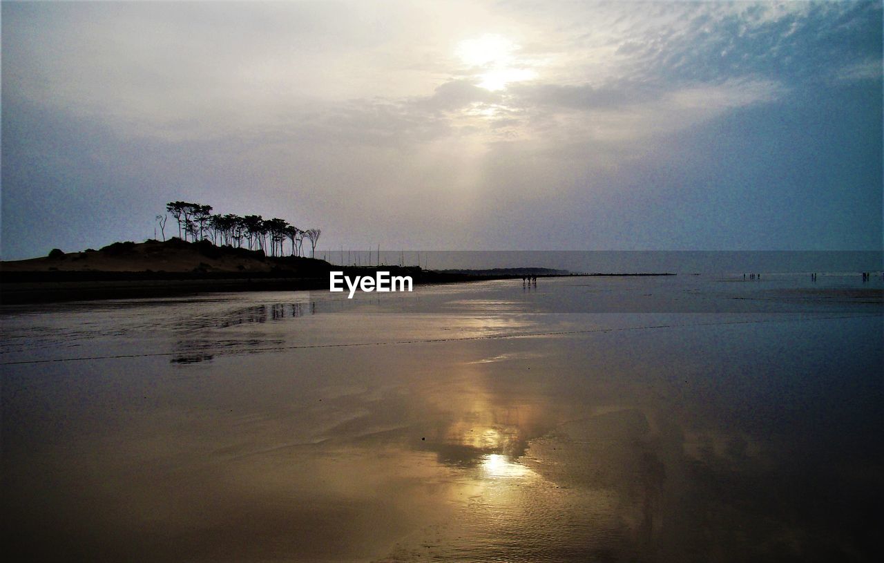 SCENIC VIEW OF BEACH AGAINST SKY DURING SUNSET