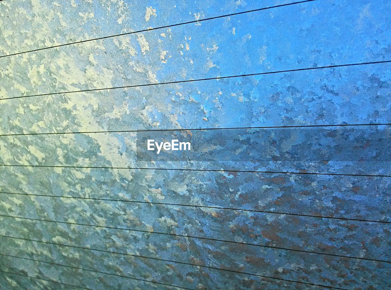 Full frame shot of frozen car window during winter
