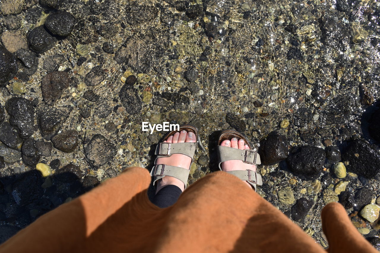 LOW SECTION OF PEOPLE STANDING ON ROCK