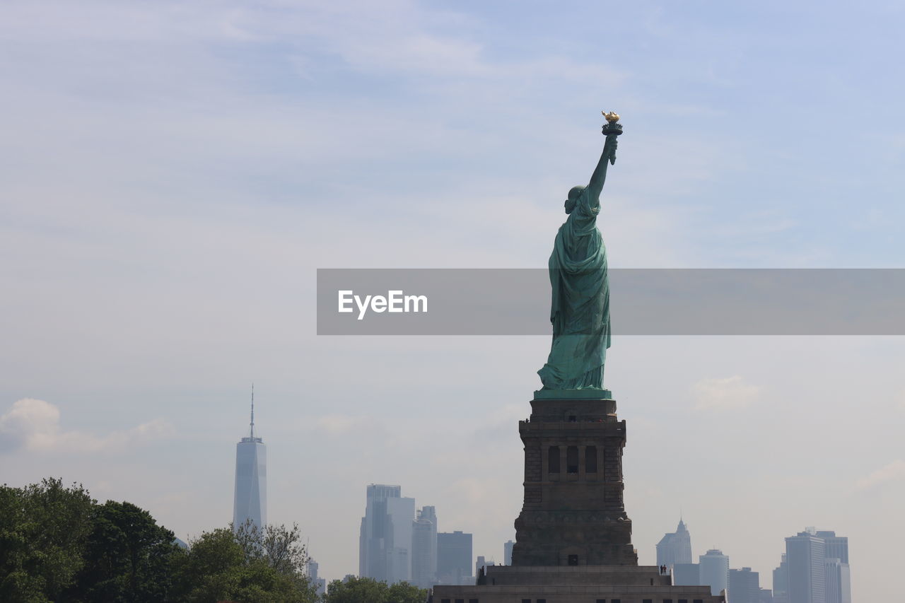 Statue of liberty with freedom tower in the background