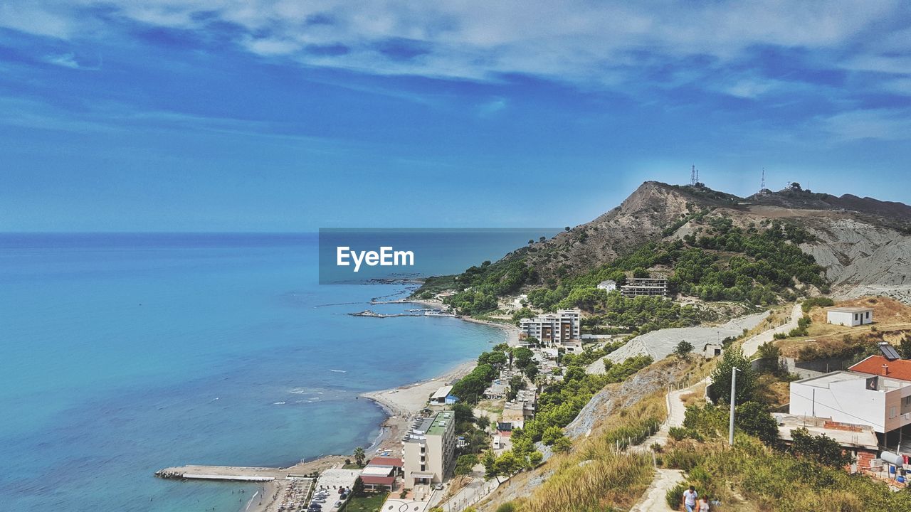 High angle view of sea and buildings against sky