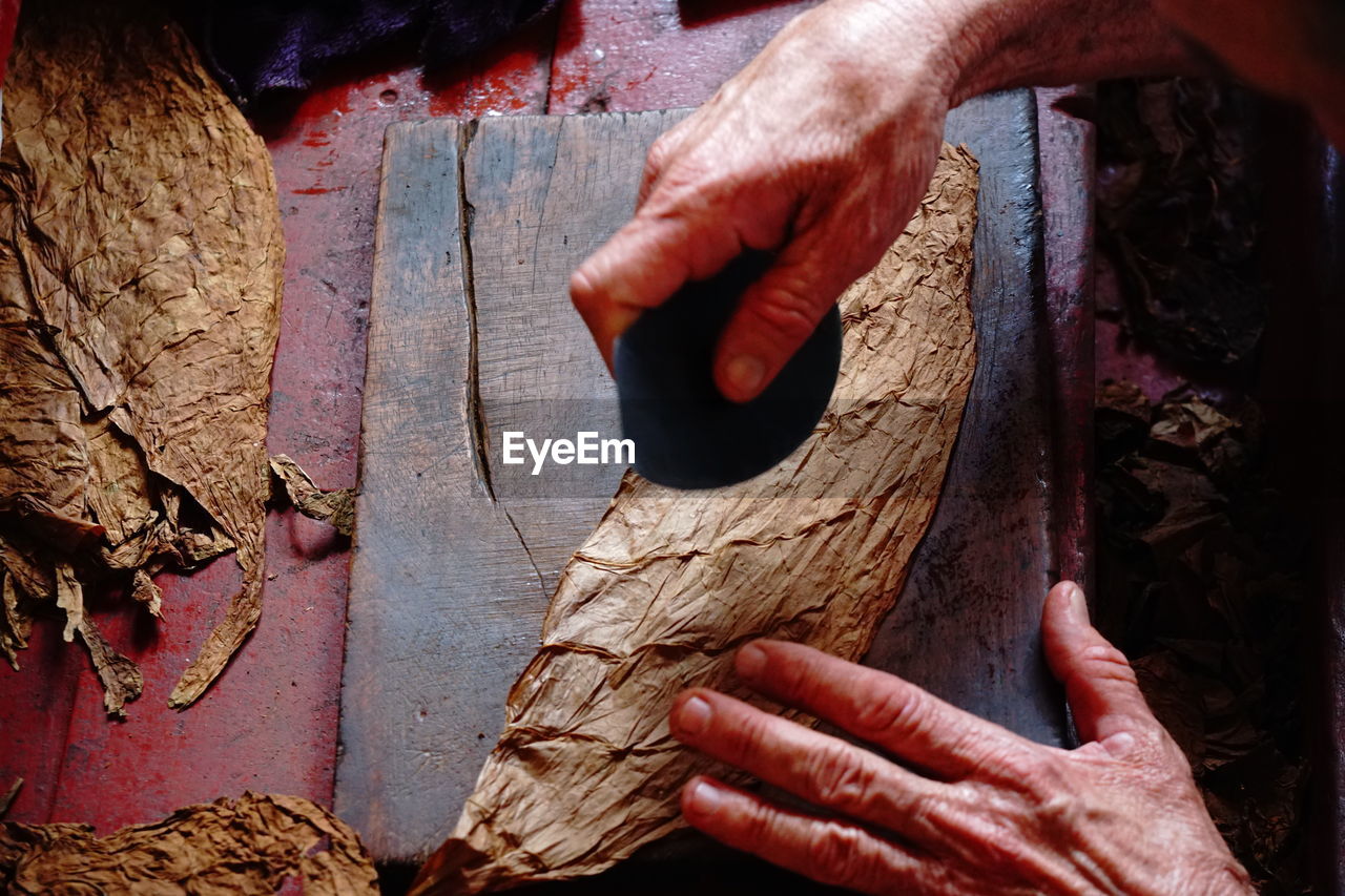 MIDSECTION OF MAN WORKING WITH WOOD